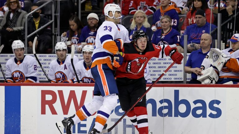 New York Islanders defenceman Zdeno Chara (33) checks New Jersey Devils right wing Alexander Holtz during the second period of an NHL hockey game Thursday, Nov. 11, 2021, in Newark, N.J. (Adam Hunger/AP Photo) 
