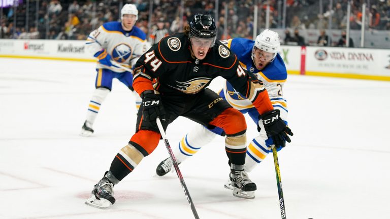 Anaheim Ducks' Max Comtois, left, moves the puck under pressure by Buffalo Sabres' Kyle Okposo during the second period of an NHL hockey game. (Jae C. Hong/AP)