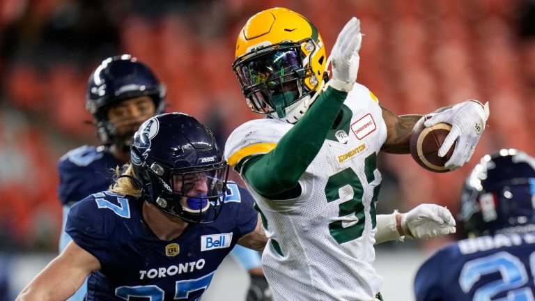 Edmonton Elks running back James Wilder Jr. (32) runs the ball past Toronto Argonauts defensive back Josh Hagerty (27) during second half CFL football action in Toronto, Tuesday, Nov. 16, 2021. (Nathan Denette/THE CANADIAN PRESS) 
