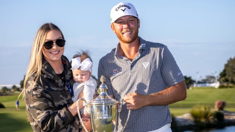 Talor Gooch, right, holds the championship trophy while standing next to his wife Ally, left, and 4-month-old daughter Collins after the final round of the RSM Classic golf tournament, Sunday, Nov. 21, 2021, in St. Simons Island, Ga. (Stephen B. Morton/AP)