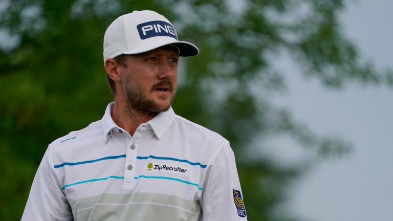 Mackenzie Hughes watches his shot off the fourth tee in the second round at the Northern Trust golf tournament, Friday, Aug. 20, 2021, at Liberty National Golf Course in Jersey City, N.J. (John Minchillo/AP Photo) 
