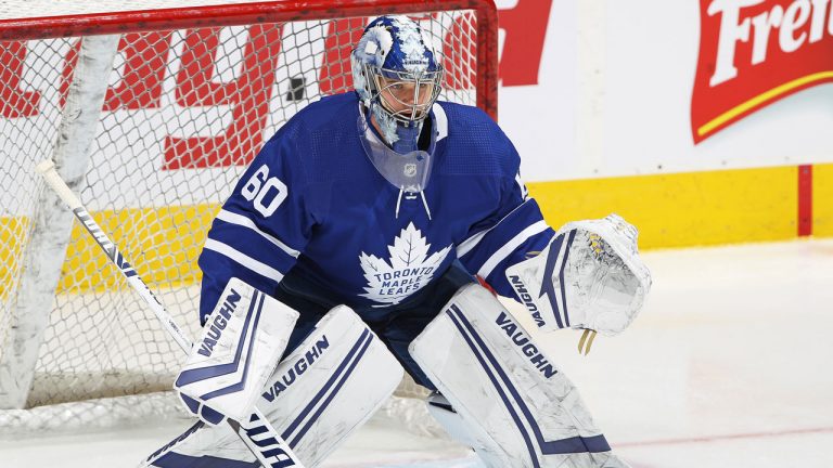 Joseph Woll #60 of the Toronto Maple Leafs faces a shot in warm-up prior to action against the Calgary Flames. (Claus Andersen/Getty Images)