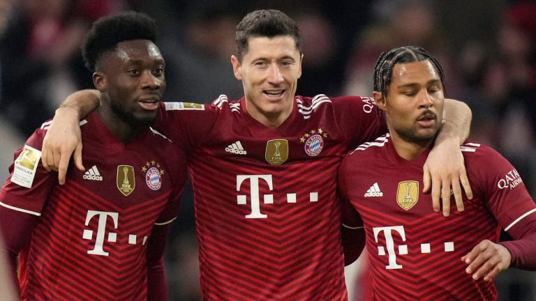 Bayern's Robert Lewandowski, center, celebrates his side's second goal with Bayern's Alphonso Davies, left, and Serge Gnabry. (Matthias Schrader/AP) 