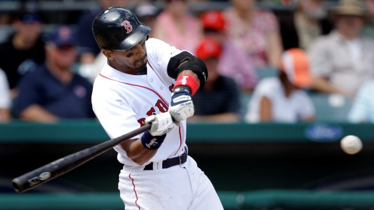 Boston Red Sox's Julio Lugo swings on his RBI-double in the second inning of their spring training baseball game against the Tampa Bay Rays in Fort Myers, Fla., Sunday, March 8, 2009. (Charles Krupa/AP)