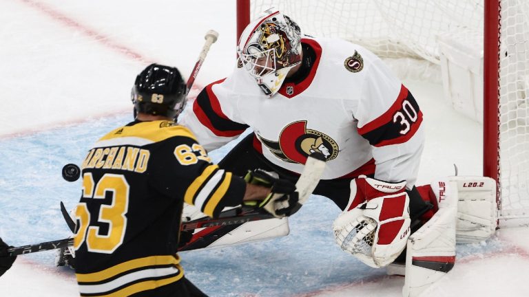 Ottawa Senators goaltender Matt Murray makes a save as Boston Bruins' Brad Marchand looks for the rebound during the first period of an NHL hockey game Tuesday, Nov. 9, 2021, in Boston. (Winslow Townson/AP)