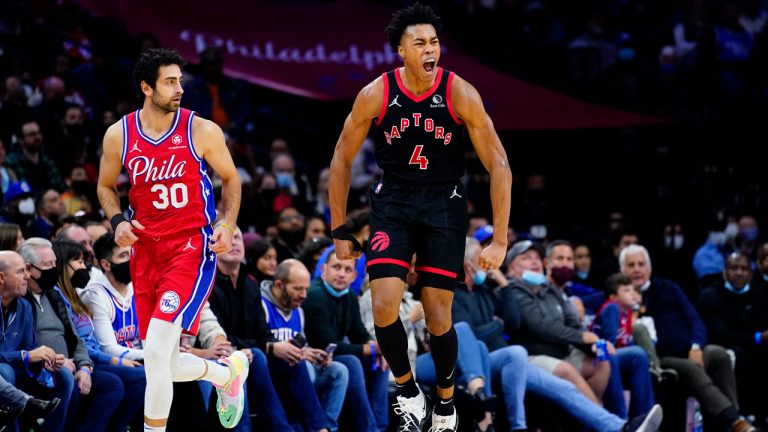 Toronto Raptors' Scottie Barnes, right, reacts past Philadelphia 76ers' Furkan Korkmaz after a making a basket during the second half of an NBA basketball game. (Matt Slocum/AP) 