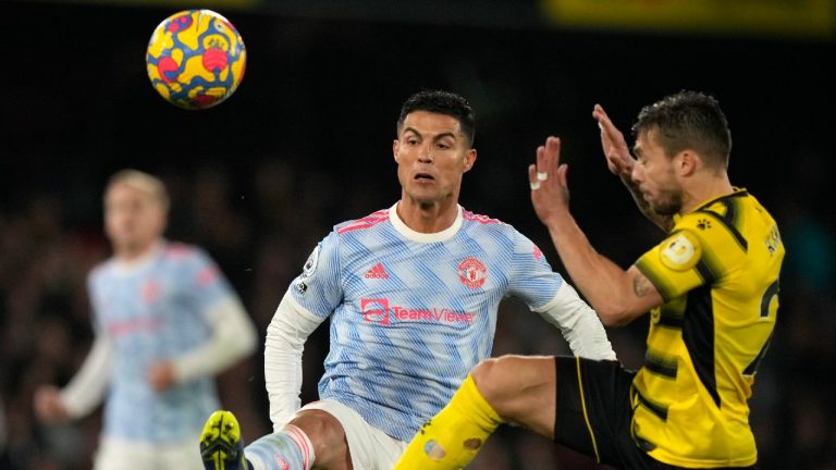 Manchester United's Cristiano Ronaldo, left, duels for the ball with Watford's Kiko Femenia during the English Premier League soccer match between Watford and Manchester United at Vicarage Road, Watford, England, Saturday, Nov. 20, 2021. (Frank Augstein/AP)