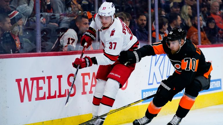 Carolina Hurricanes' Andrei Svechnikov, left, clears the puck away from Philadelphia Flyers' Rasmus Ristolainen during the first period of an NHL hockey game. (Matt Slocum/AP) 