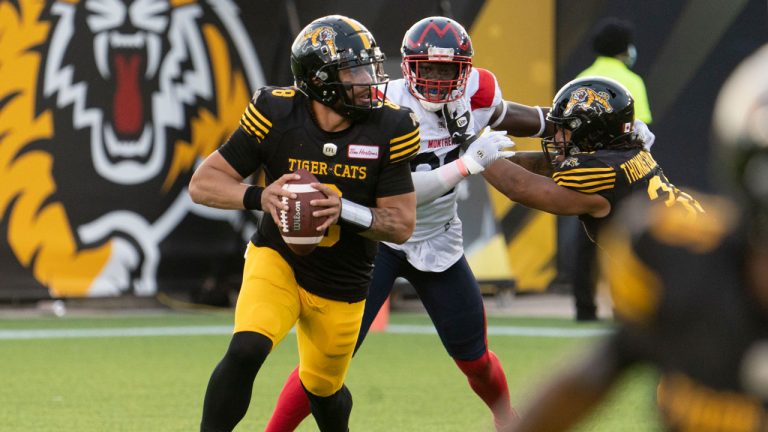 Hamilton Tiger Cats quarterback Jeremiah Masoli(8) scrambles under pressure during second half CFL football game against the Montreal Alouettes in Hamilton. (Peter Power/CP)