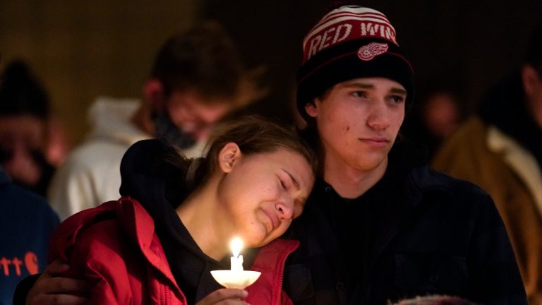 People attending a vigil embrace at LakePoint Community Church in Oxford, Mich., Tuesday, Nov. 30, 2021. Authorities say a 15-year-old sophomore opened fire at Oxford High School, killing several students and wounding multiple other people, including a teacher. (Paul Sancya/AP Photo) 
