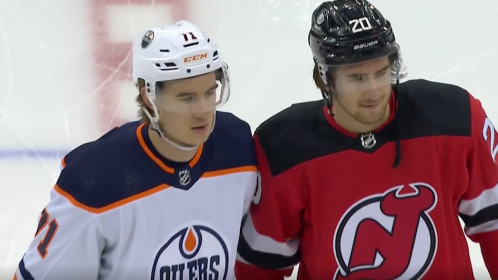 Ryan McLeod of the Edmonton Oilers signs a stick prior to the game