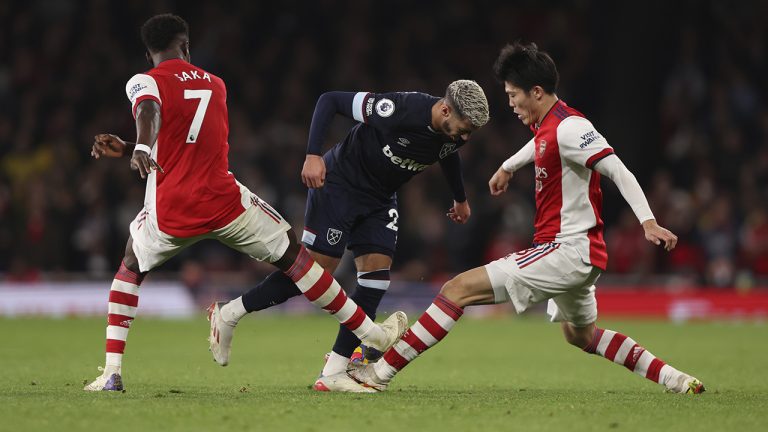 West Ham's Said Benrahma, centre, fights for the ball with Arsenal's Takehiro Tomiyasu, right, and Arsenal's Bukayo Saka. (Ian Walton/AP)