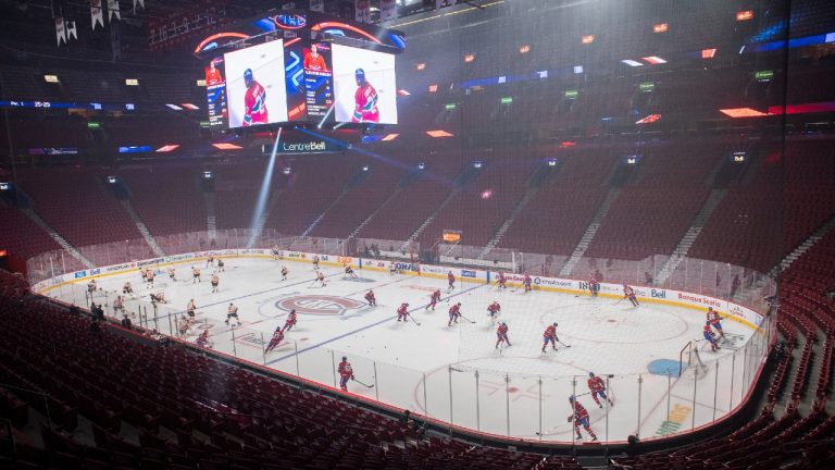 Players from the Montreal Canadiens and the Philadelphia Flyers skate before an empty arena prior to an NHL game in Montreal, Thursday, December 16, 2021. (Graham Hughes/CP) 