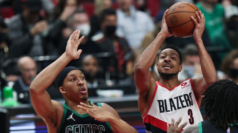 Portland Trail Blazers guard CJ McCollum, right, drives against Boston Celtics forward Grant Williams, left, during the second half of an NBA basketball game in Portland, Ore., Saturday, Dec. 4, 2021. The Celtics won 145-117 (Steve DiPaola/AP).
