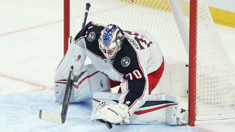 Columbus Blue Jackets goaltender Joonas Korpisalo traps a blocked shot under his glove during the third period of the team's NHL hockey game against the Buffalo Sabres on Monday, Nov. 22, 2021, in Buffalo, N.Y. (AP/file) 