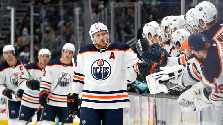 Edmonton Oilers center Leon Draisaitl (29) is congratulated by teammates after scoring against the Seattle Kraken during the first period of an NHL hockey game Friday, Dec. 3, 2021, in Seattle. (AP Photo/Elaine Thompson) 