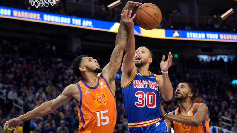 Phoenix Suns guard Cameron Payne (15) defends against a shot attempt by Golden State Warriors guard Stephen Curry (30) during the first half of an NBA basketball game in San Francisco, Friday, Dec. 3, 2021. (AP/file) 