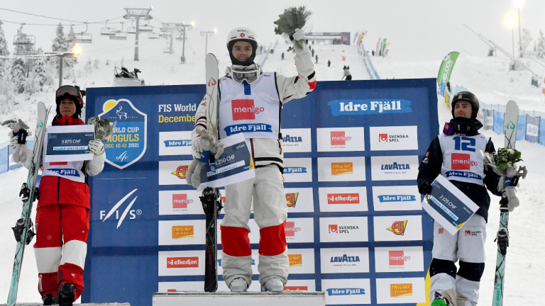 From left, Ikuma Horishima of Japan second place, Mikael Kingsbury of Canada first place and Sweden's Ludvig Fjallstrom third place in Men's Freestyle Skiing Dual Moguls final competition of the FIS Freestyle Ski World Cup 2021/22 in Idre, Sweden on Sunday. (AP) 