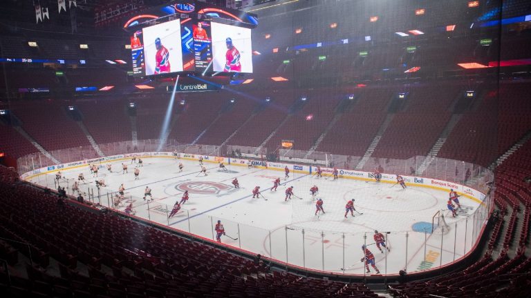 Players from the Montreal Canadiens and the Philadelphia Flyers skate before an empty arena prior to an NHL game in Montreal, Thursday, December 16, 2021. (Graham Hughes/CP)