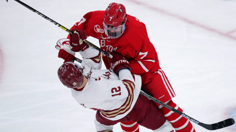 Boston University defenseman Chad Krys drops Boston College forward Matt Boldy in the NCAA Beanpot Tournament game in Boston, Monday, Feb. 3, 2020. (AP/file) 