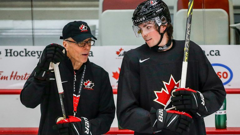 Head coach Dave Cameron, left, chats with Owen Power during a practice at the Canadian World Junior Hockey Championships selection camp. (Jeff McIntosh/CP)