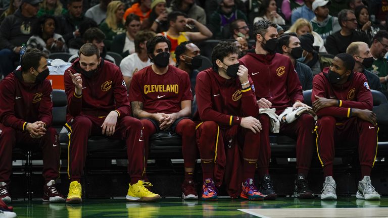 The Cleveland Cavaliers bench players all wear masks during the first half of an NBA basketball game against the Milwaukee Bucks. (Morry Gash/AP)