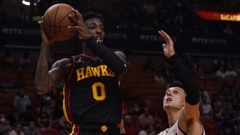 Atlanta Hawks guard Brandon Goodwin (0) looks to pass the ball under pressure from Miami Heat guard Tyler Herro. (Marta Lavandier/AP)