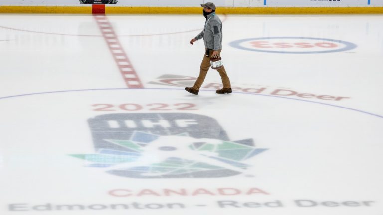 An ice technician walks past centre ice after the IIHF World Junior Hockey Championship was cancelled in Red Deer, Alberta on Wednesday, Dec. 29, 2021. (Jeff McIntosh/CP)