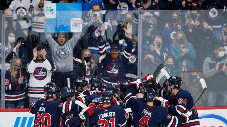 Winnipeg Jets players and fans celebrate Mark Scheifele’s (55) game winning goal against the Los Angeles Kings during overtime NHL action in Winnipeg on Saturday, November 13, 2021. (John Woods/THE CANADIAN PRESS)
