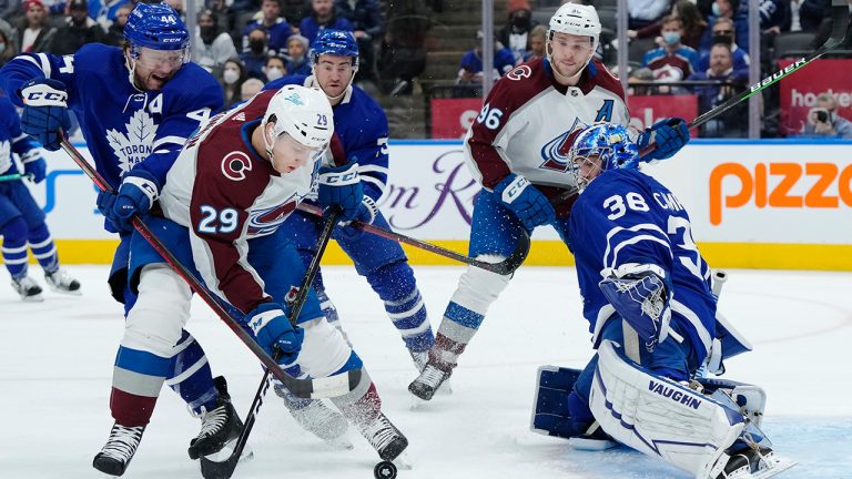 Toronto Maple Leafs goaltender Jack Campbell (36) makes a save on Colorado Avalanche forward Nathan MacKinnon (29) as Maple Leafs defenceman Morgan Rielly (44) defends. (Nathan Denette/CP)