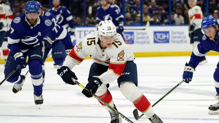 Florida Panthers center Anton Lundell (15) goes in on a break-away after getting around Tampa Bay Lightning defenseman Victor Hedman (77) and left wing Ross Colton (79) during the first period of an NHL hockey game Tuesday, Oct. 19, 2021, in Tampa, Fla. (Chris O'Meara/AP) 
