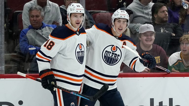 Edmonton Oilers left wing Zach Hyman (18) celebrates his short-handed goal against the Arizona Coyotes with center Ryan Nugent-Hopkins, right, during the second period of an NHL hockey game. (Ross D. Franklin/AP)