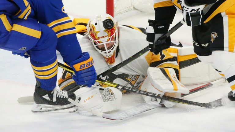 Pittsburgh Penguins goalie Louis Domingue (70) makes a save in traffic during the third period of a preseason NHL hockey game against the Buffalo Sabres, Friday, Oct. 1, 2021, in Buffalo, N.Y. (Jeffrey T. Barnes/AP)