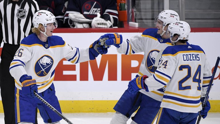 Buffalo Sabres' Rasmus Dahlin (26) celebrates his goal against the Winnipeg Jets with Tage Thompson (72) and Dylan Cozens (24). (Fred Greenslade/CP)