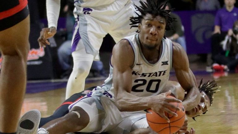 Kansas State forward Xavier Sneed (20) goes to the floor after the ball with Texas Tech guard Jahmi'us Ramsey, back, during the second half of an NCAA college basketball game in Manhattan, Kan., Tuesday, Jan. 14, 2020. Texas Tech defeated Kansas State 77-63. (Orlin Wagner/AP) 