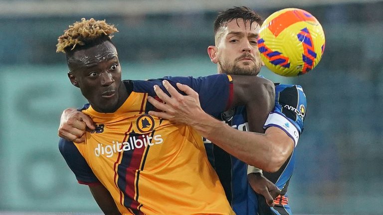 Roma's Tammy Abraham, left, and Atalanta's Rafael Toloi battle for the ball during the Serie A soccer match between Calcio Atalanta and AS Roma at Gewis Stadium, Bergamo, Italy, Saturday Dec. 18, 2021. (Spada/LaPresse via AP)