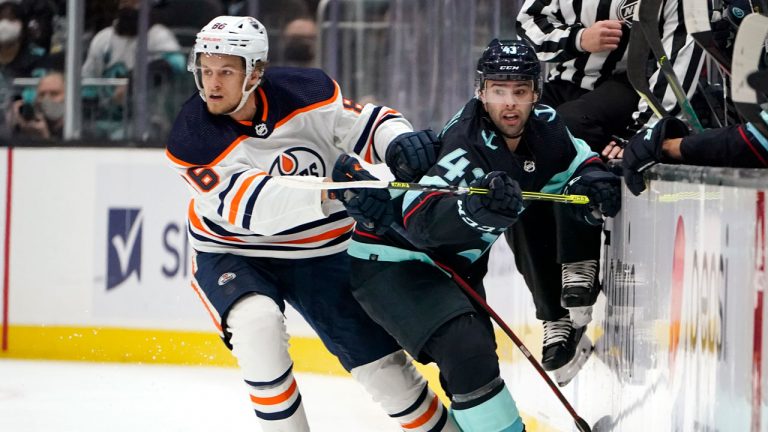 Edmonton Oilers defenseman Philip Broberg (86) collides with Seattle Kraken center Colin Blackwell (43) during the first period of an NHL hockey game. (Elaine Thompson/AP) 