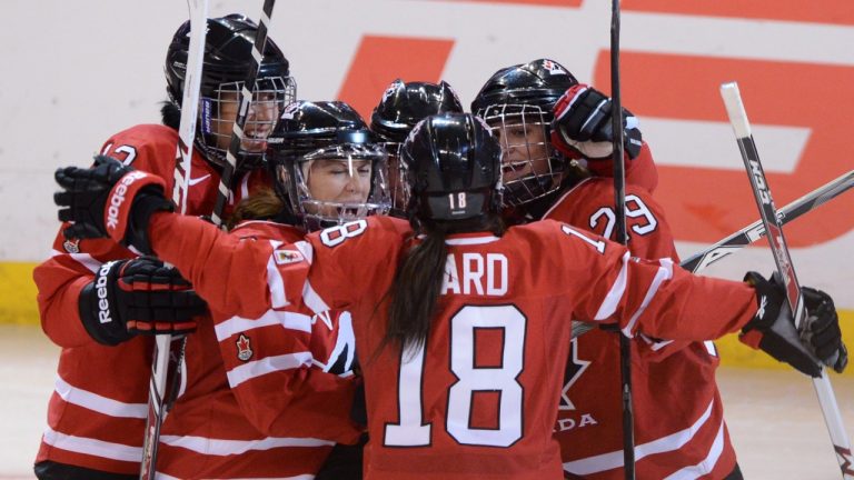 Team Canada's Courtney Birchard , centre back, is congradulated by teammates Caroline Ouellette, left, Jayna Hefford,Catherine Ward, 18, Marie-Philip Poulin, right, during first period action against Team USA in the gold medal game at IIHF Women's World Ice Hockey championships in Ottawa, Tuesday April 9, 2013. (Sean Kilpatrick/THE CANADIAN PRESS)
