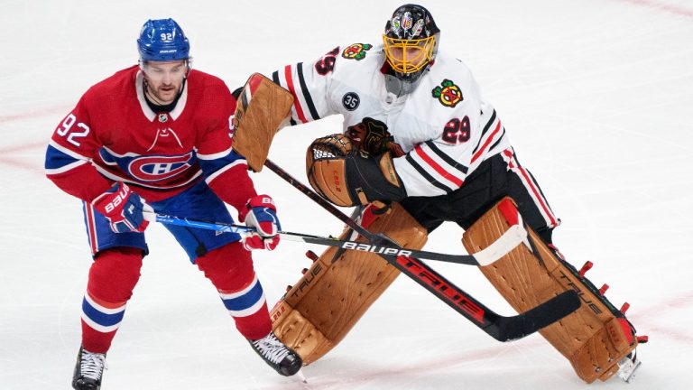 Chicago Blackhawks goaltender Marc-Andre Fleury fends off Montreal Canadiens' Jonathan Drouin after clearing the puck during second period NHL hockey action in Montreal on Thursday, December 9, 2021. (Paul Chiasson/THE CANADIAN PRESS)
