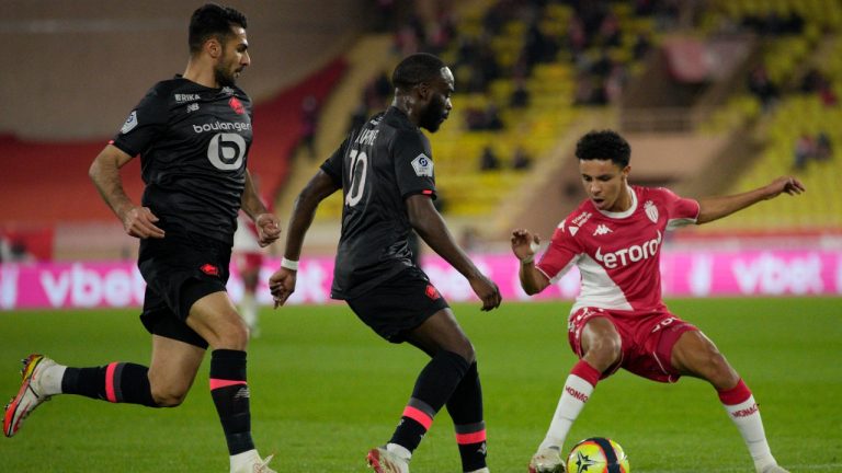 Monaco's Sofiane Diop, right, duels for the ball with Lille's Jonathan Ikone, centre, and Lille's Zeki Celik during the French League One soccer match between Monaco and Lille at the Stade Louis II in Monaco, Friday, Nov. 19, 2021. (Daniel Cole/AP)