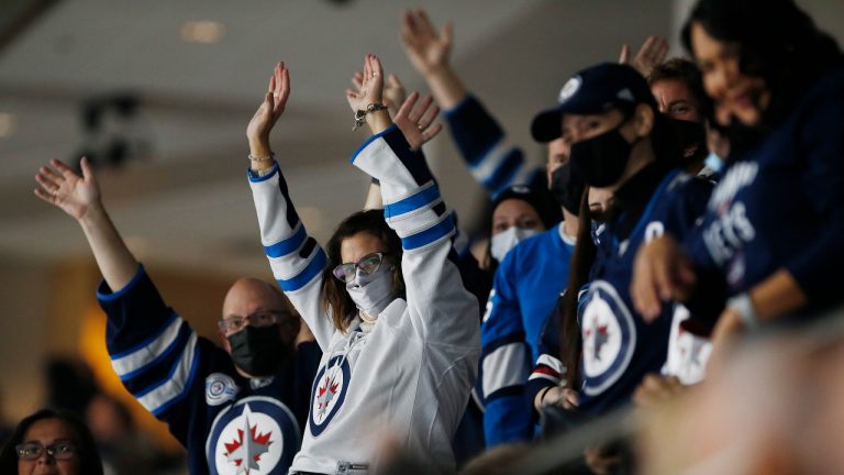 Winnipeg Jets fans cheer as the home opener gets underway against the Anaheim Ducks in NHL action in Winnipeg on Thursday, October 21, 2021. (John Woods/THE CANADIAN PRESS)
