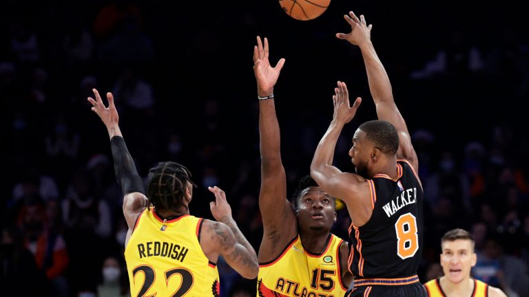 New York Knicks guard Kemba Walker (8) passes over Atlanta Hawks center Clint Capela (15) during the first half of an NBA basketball game. (Adam Hunger/AP) 