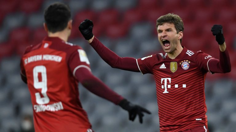 Bayern's Thomas Mueller, right, celebrates with Bayern's Robert Lewandowski after scoring his sides first goal during a German Bundesliga soccer match between Bayern Munich and VfL Wolfsburg at the Allianz Arena. (Andreas Schaad/AP)