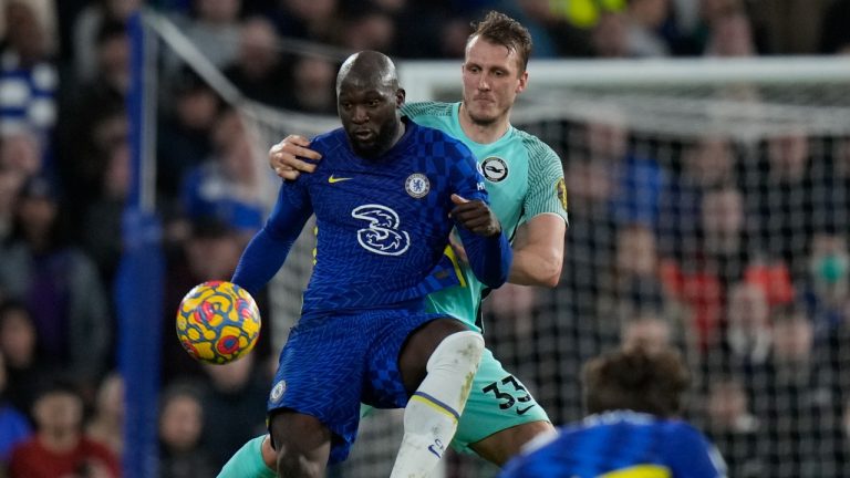 Chelsea's Romelu Lukaku, left, is challenged by Brighton's Dan Burn during the English Premier League soccer match between Chelsea and Brighton at Stamford Bridge Stadium in London, England, Wednesday, Dec. 29, 2021. (Alastair Grant/AP)