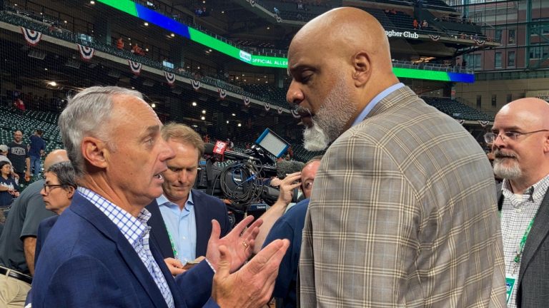 Baseball Commissioner Rob Manfred, left, and Major League Baseball Players Association executive director Tony Clark speak before Game 1 in baseball's World Series between the Houston Astros and the Atlanta Braves, Oct. 26, 2021, in Houston. (Ron Blum/AP)