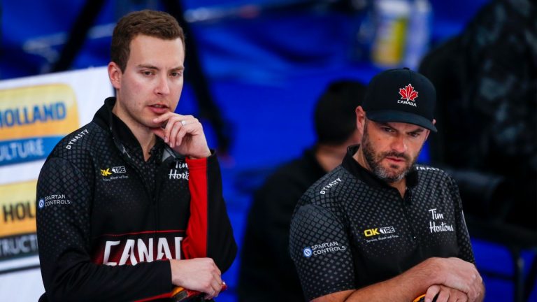 Team Canada skip Brendan Bottcher, left, and third Darren Moulding discuss strategy against Italy at the Men's World Curling Championships in Calgary, Alta., Tuesday, April 6, 2021. (Jeff McIntosh/CP)