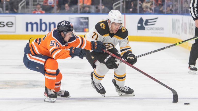 Boston Bruins' Taylor Hall (71) tries to get past Edmonton Oilers' Kailer Yamamoto (56) during first period NHL hockey action in Edmonton, Alta., on Thursday, December 9, 2021. (Amber Bracken/THE CANADIAN PRESS)
