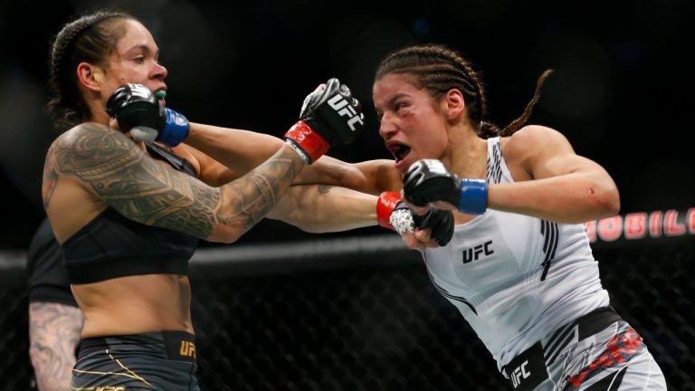 Julianna Pena, right, hits Amanda Nunes during a women's bantamweight mixed martial arts title bout at UFC 269, Saturday, Dec. 11, 2021, in Las Vegas. (Chase Stevens/AP)