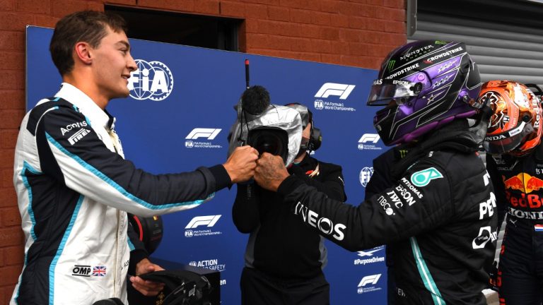 Second place Williams driver George Russell of Britain, left, fist bumps with third place Mercedes driver Lewis Hamilton of Britain after the qualification ahead of the Formula One Grand Prix at the Spa-Francorchamps racetrack in Spa, Belgium, Saturday, Aug. 28, 2021. (John Thys/AP)