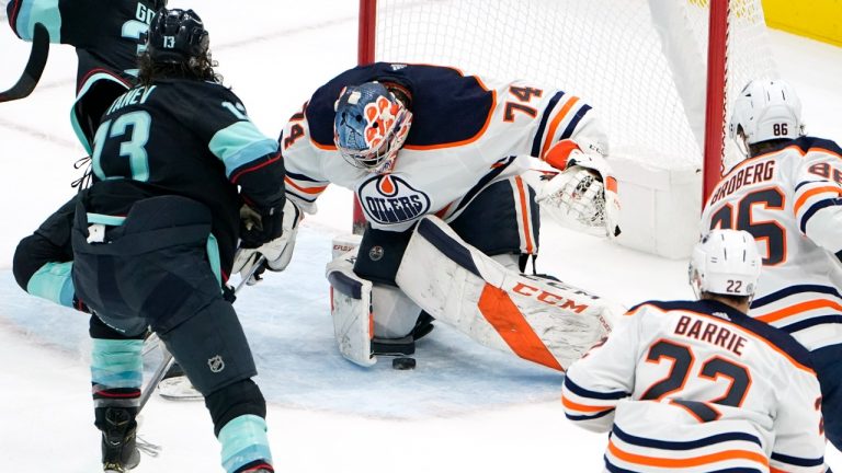 Edmonton Oilers goaltender Stuart Skinner (74) looks for the puck during the third period of the team's NHL hockey game against the Seattle Kraken on Friday, Dec. 3, 2021, in Seattle. The Kraken won 4-3. (Elaine Thompson/AP)